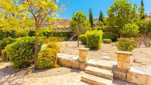 A landscaped garden with stone steps leading up to a viewing area, surrounded by various shrubs and trees. - Villa Fortuna Large Private Pool Walk to Beach Sea Views A C Wifi Car Not Required - 2630 (Polis)