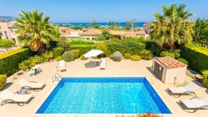 A swimming pool with lounge chairs and a view of the sea. - Villa Fortuna Large Private Pool Walk to Beach Sea Views A C Wifi Car Not Required - 2630 (Polis)