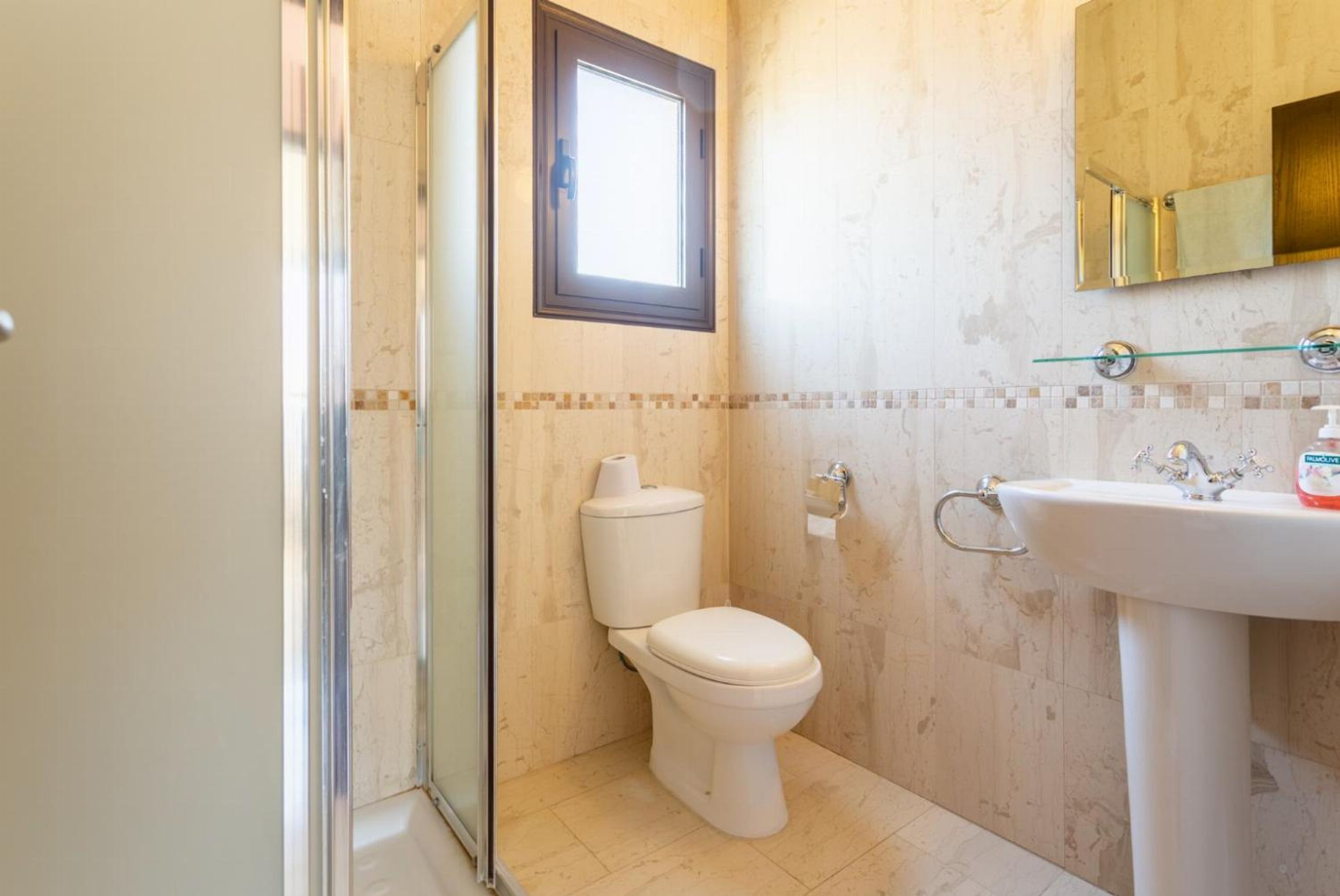 A bathroom with a toilet, a sink, and a shower.