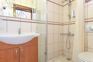 A bathroom with a white sink, wooden cabinet, glass shower enclosure, and a toilet. - Villa Asli Paradise Private Pool A C Wifi Car Not Required Eco-friendly - 2226 (Ortaca)