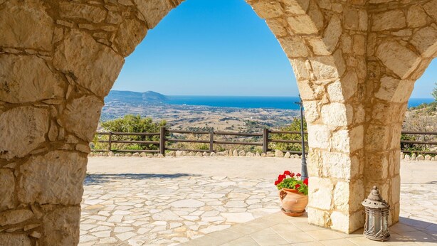 A stone archway leading to a terrace with a view of the sea and distant hills. - Villa Heaven Large Private Pool Sea Views A C Wifi Eco-friendly - 2645 (Peristerona)
