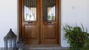 A wooden double door with glass panels and metal decorative elements. - Villa Heaven Large Private Pool Sea Views A C Wifi Eco-friendly - 2645 (Peristerona)