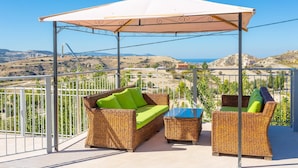 A balcony with wicker furniture, a white canopy, and a scenic view of hills and the sea. - Villa Christel Large Private Pool A C Wifi Eco-friendly - 2761 (Peristerona)