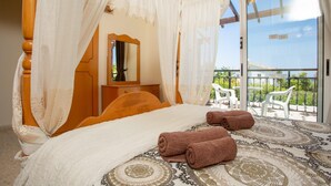 A bedroom with a four-poster bed, a wooden dresser, and a balcony with outdoor furniture. - Sun Beach Villa Thio Large Private Pool Walk to Beach A C Wifi Car Not Required - 2840 (Polis)