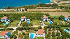 A coastal property with multiple villas, each with a pool and surrounded by greenery. - Sun Beach Villa Thio Large Private Pool Walk to Beach A C Wifi Car Not Required - 2840 (Polis)