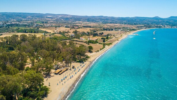 An aerial view of a coastal area with a beach, clear blue waters, and a mix of residential and agricultural land in the background. - Sun Beach Villa Thio Large Private Pool Walk to Beach A C Wifi Car Not Required - 2840 (Polis)