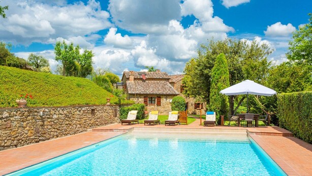 A swimming pool with lounge chairs and a stone wall. - Villa Bramasole Large Private Pool Wifi - 2863 (Sinalunga)