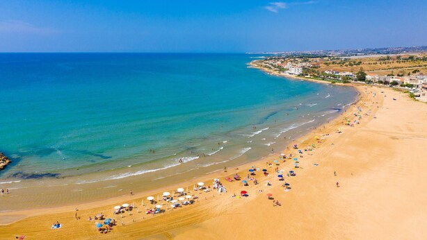 A beach with clear blue waters, sandy shore, and a few umbrellas and beach chairs. - Villa Palazzola Large Private Pool Sea Views A C Wifi - 2886 (Scicli)