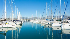 A marina with numerous sailboats docked in calm waters, reflecting the clear blue sky. - Villa Durrell Large Private Pool Walk to Beach A C Wifi - 2927 (Corfu)