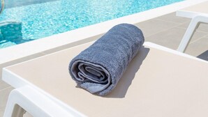 A poolside view with a towel on a lounge chair, overlooking a body of water and greenery. - Villa Lassi Fos Large Private Pool Walk to Beach Sea Views A C Wifi - 3056 (Kefalonia)