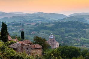 A historic stone building with a dome, surrounded by lush green hills and a clear sky. - Villa Casale Le Selve Large Private Pool Wifi - 3099 (Castiglione di Garfagnana)