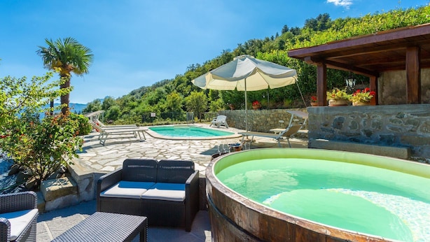 A pool area with two pools, lounge chairs, and a hot tub. - Villa Casale Le Selve Large Private Pool Wifi - 3099 (Castiglione di Garfagnana)