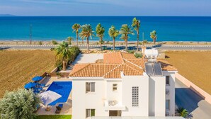 A modern building with a rooftop pool, palm trees, and a view of the sea. - Villa Seashore One Large Private Pool Walk to Beach Sea Views A C Wifi - 3150 (Argaka)