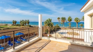 A balcony with a view of the sea, palm trees, and a sandy area. - Villa Seashore One Large Private Pool Walk to Beach Sea Views A C Wifi - 3150 (Argaka)