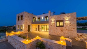 A modern two-story house with stone walls and a well-lit entrance. - Villa Lulla Large Heated Private Pool Sea Views A C Wifi - 3200 (Chania)