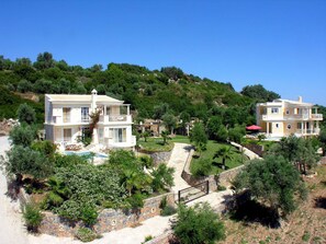 A hillside property with two multi-story buildings, a swimming pool, and a well-maintained garden. - Villa Callistemon Large Private Pool Sea Views A C Wifi - 3269 (Rethymno)