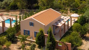 A building with a tiled roof, a swimming pool, and a view of the sea. - Nafsika Beach House Large Private Pool Walk to Beach Sea Views A C Wifi Car Not Required - 1880 (Kefalonia)