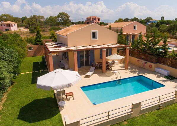 A two-story house with a swimming pool, outdoor seating, and a pergola. - Nafsika Beach House Large Private Pool Walk to Beach Sea Views A C Wifi Car Not Required - 1880 (Kefalonia)