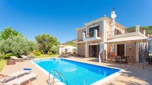 A two-story house with a swimming pool, outdoor furniture, and a garden. - Villa Eufrosini Large Private Pool Walk to Beach Sea Views A C Wifi Car Not Required - 2301 (Kefalonia)