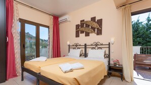 A bedroom with two beds, a balcony, and a view of the outside. - Villa Eufrosini Large Private Pool Walk to Beach Sea Views A C Wifi Car Not Required - 2301 (Kefalonia)