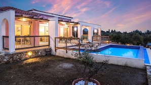 A two-story house with a swimming pool, outdoor seating, and a view of the surrounding landscape. - Vatsa Beach Villa Large Private Pool Walk to Beach Sea Views A C Wifi - 3021 (Kefalonia)