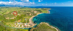 An aerial view of a coastal area with a small village, clear turquoise waters, and a winding road along the coast. - Vatsa Beach Villa Large Private Pool Walk to Beach Sea Views A C Wifi - 3021 (Kefalonia)