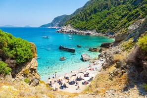 A coastal beach with clear turquoise waters, rocky cliffs, and lush greenery. - Villa Katerina Private Pool Sea Views A C Wifi - 2179 (Skopelos)