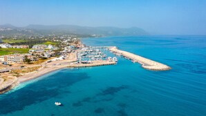 An aerial view of a coastal town with a marina, buildings, and a clear blue sea. - Villa Minoas Large Private Pool Walk to Beach Sea Views A C Wifi Eco-friendly - 2565 (Argaka)