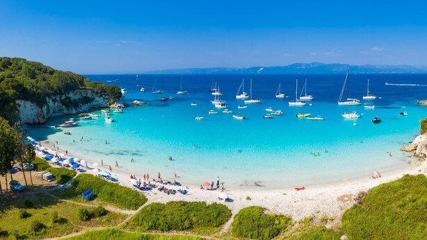 A coastal beach with clear turquoise waters, boats, and a sandy shore. - Villa Alexandros Swimming Pool Walk to Beach A C Wifi - 3454 (Paxos)