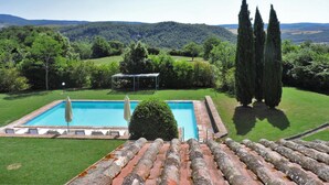 A rectangular pool with a pergola and lounge chairs, surrounded by well-maintained lawns and tall cypress trees, with a mountainous backdrop. - Villa Mealli Large Private Pool Wifi - 3445 (San Casciano dei Bagni)