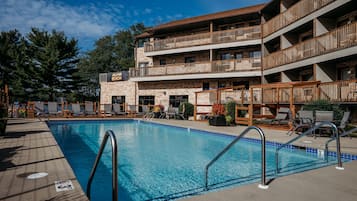 Una piscina techada, una piscina al aire libre de temporada, sombrillas
