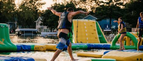 A water park with inflatable water slides and rafts.