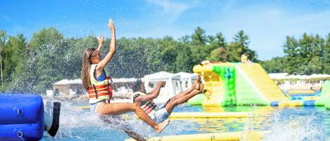 A water park with inflatable slides and a pool.