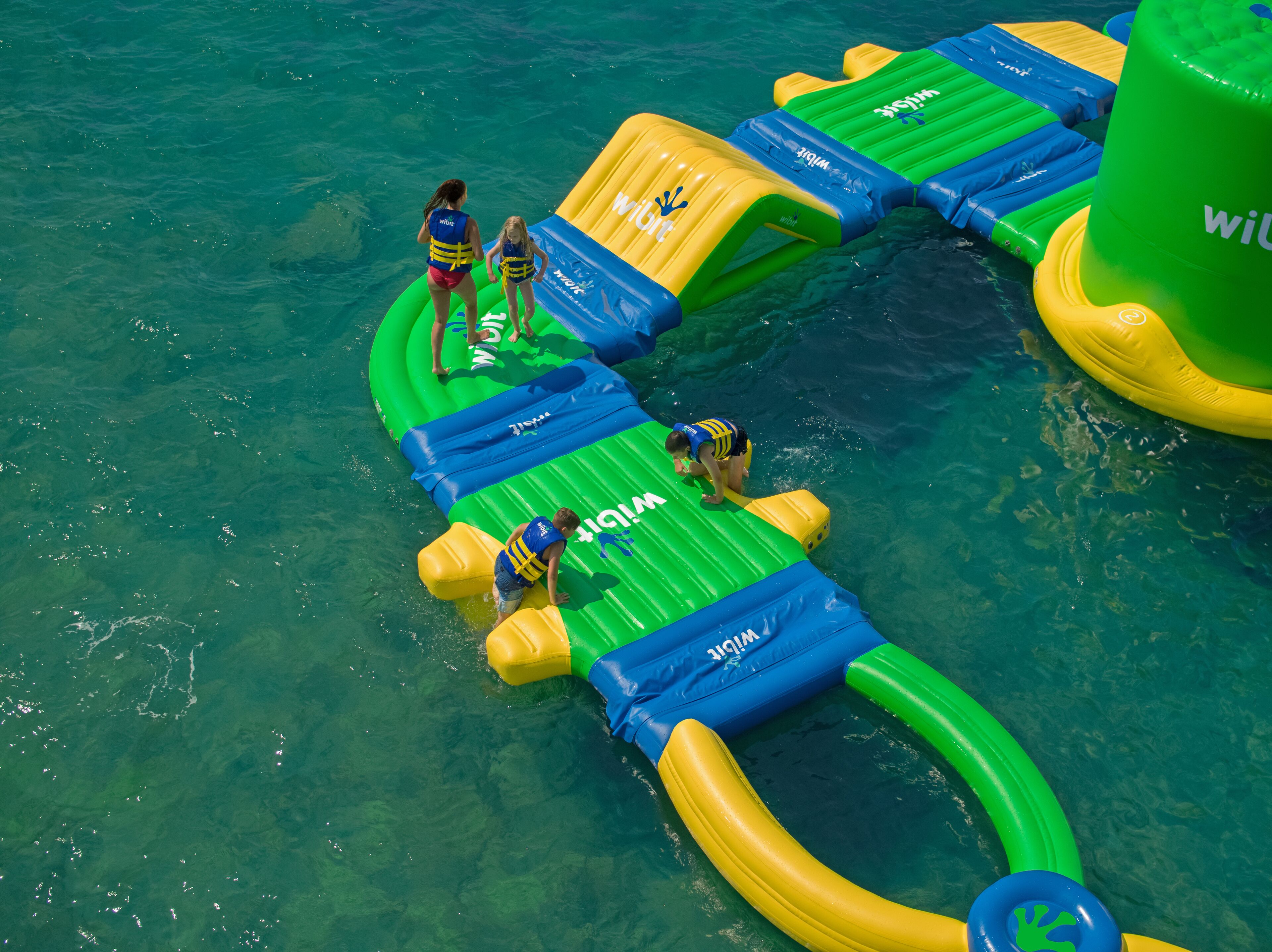 An inflatable water park with various play structures and slides.