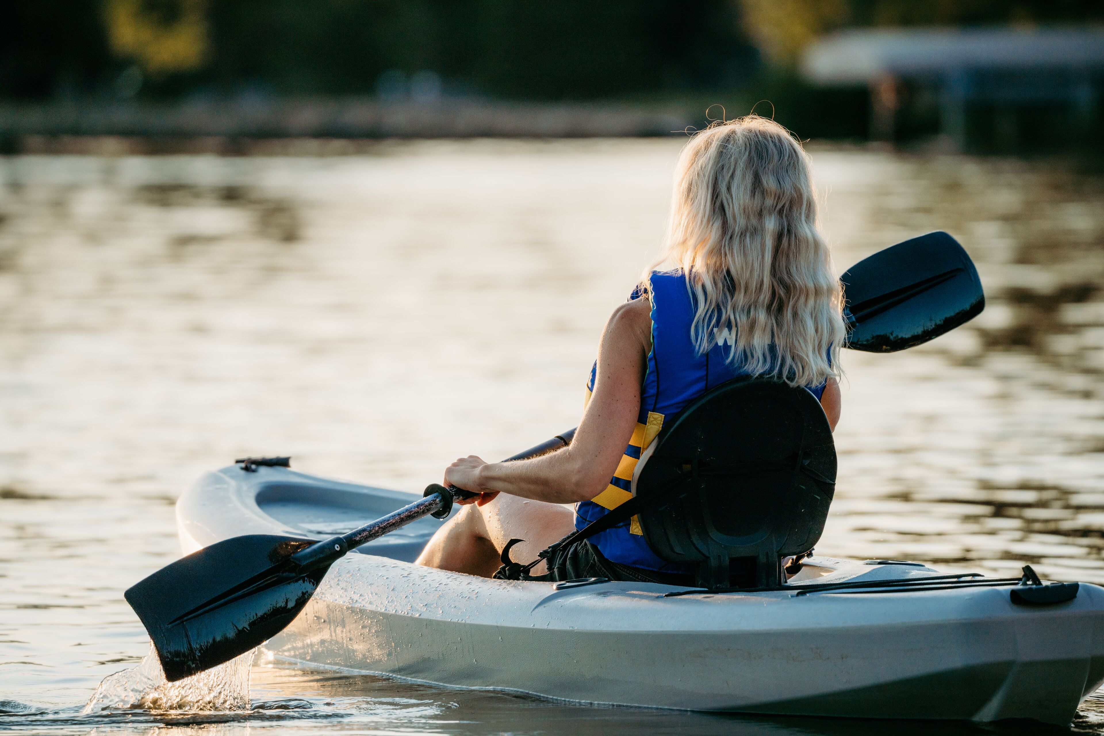 A person in a kayak on a body of water.