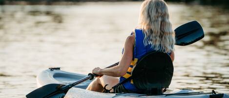 A person in a kayak on a body of water.