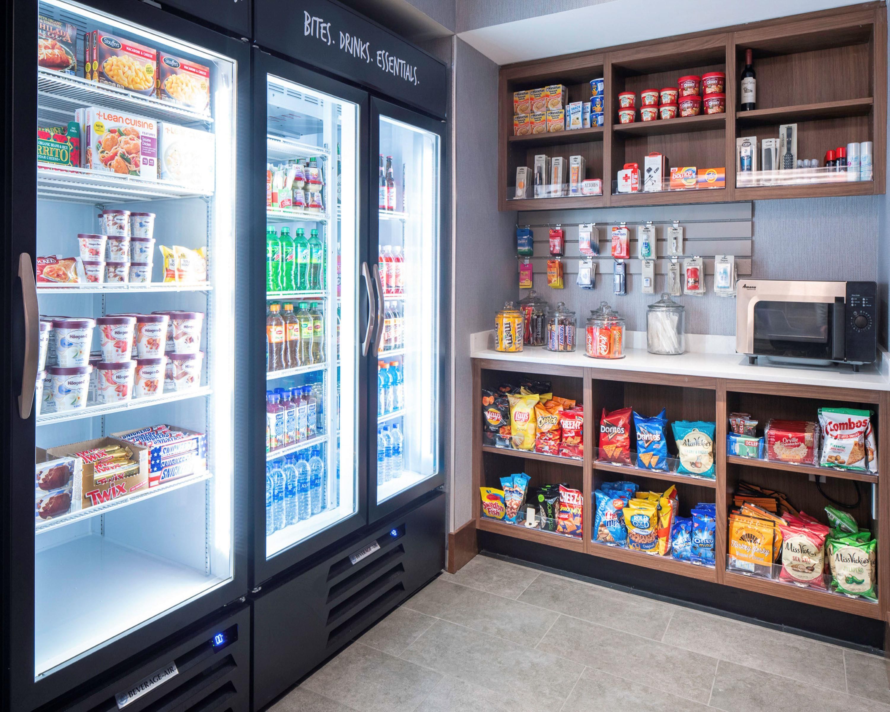 A self-service beverage area with refrigerated drinks and snacks.