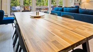 A dining area with a wooden table, blue chairs, and a blue sofa.