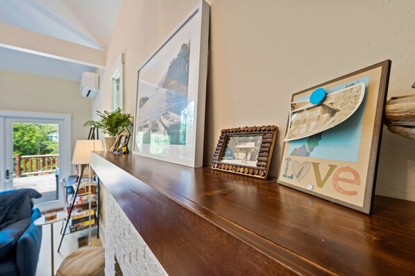 A wooden reception desk with framed pictures and a 'Love' sign.