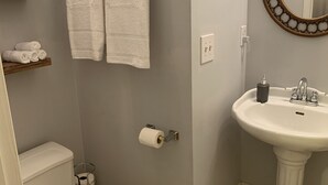 A bathroom with a toilet, sink, and towel rack. - Private room and bathroom in the heart of Cullman. (Cullman)