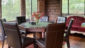 A dining area with a wooden table, leather chairs, and a vase of flowers. - Perfect getaway from your daily routine!!! (Greentown)