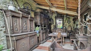 An interior with wooden furniture, a stone wall, and a wooden ceiling. - Keriker - PLOEMEL - Gîte (PLOEMEL)