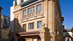Un bâtiment historique doté d’un balcon, de grandes fenêtres et d’une façade de style traditionnel.