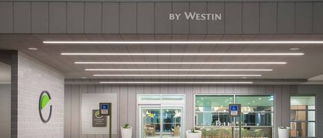 Entrada moderna de un edificio con un cartel que dice 'element by Westin'.