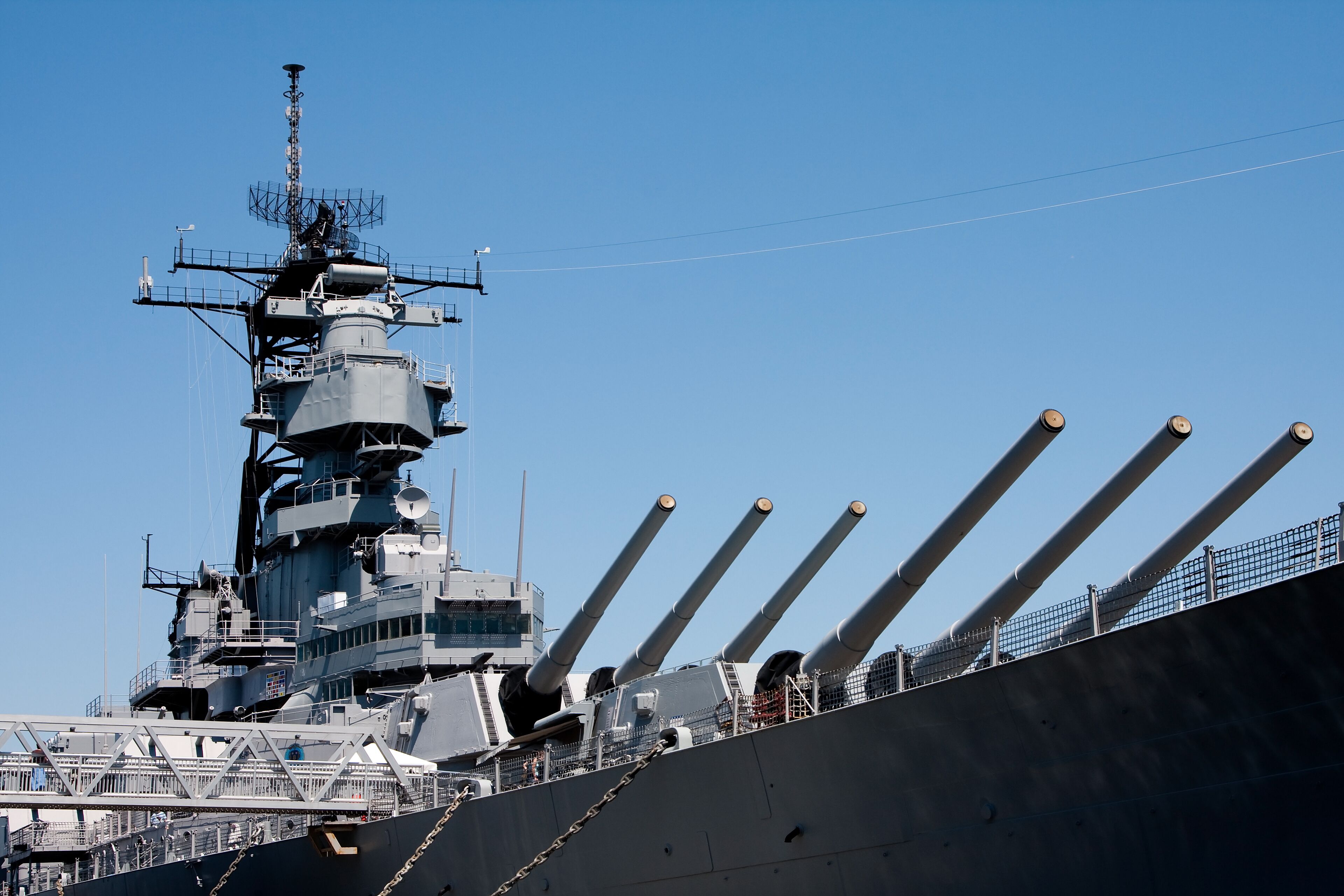 A large naval ship with multiple gun turrets and a complex superstructure.