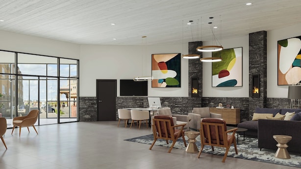 Un espacio habitable amplio con diseño moderno, que incluye un gran ventanal, una chimenea y muebles contemporáneos.
