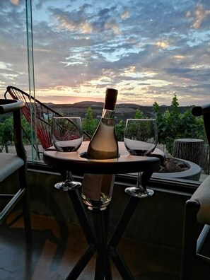 Enjoy a meal al fresco with a view of the surrounding countryside from this outdoor dining area.