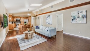 A spacious living area with a sofa, dining table, and kitchen in the background. - POOL. Spacious 4BR/2B. SF Bay Area (Newark)