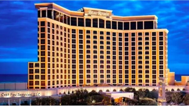 A large, multi-story hotel with a classic architectural style, featuring a prominent sign at the top.