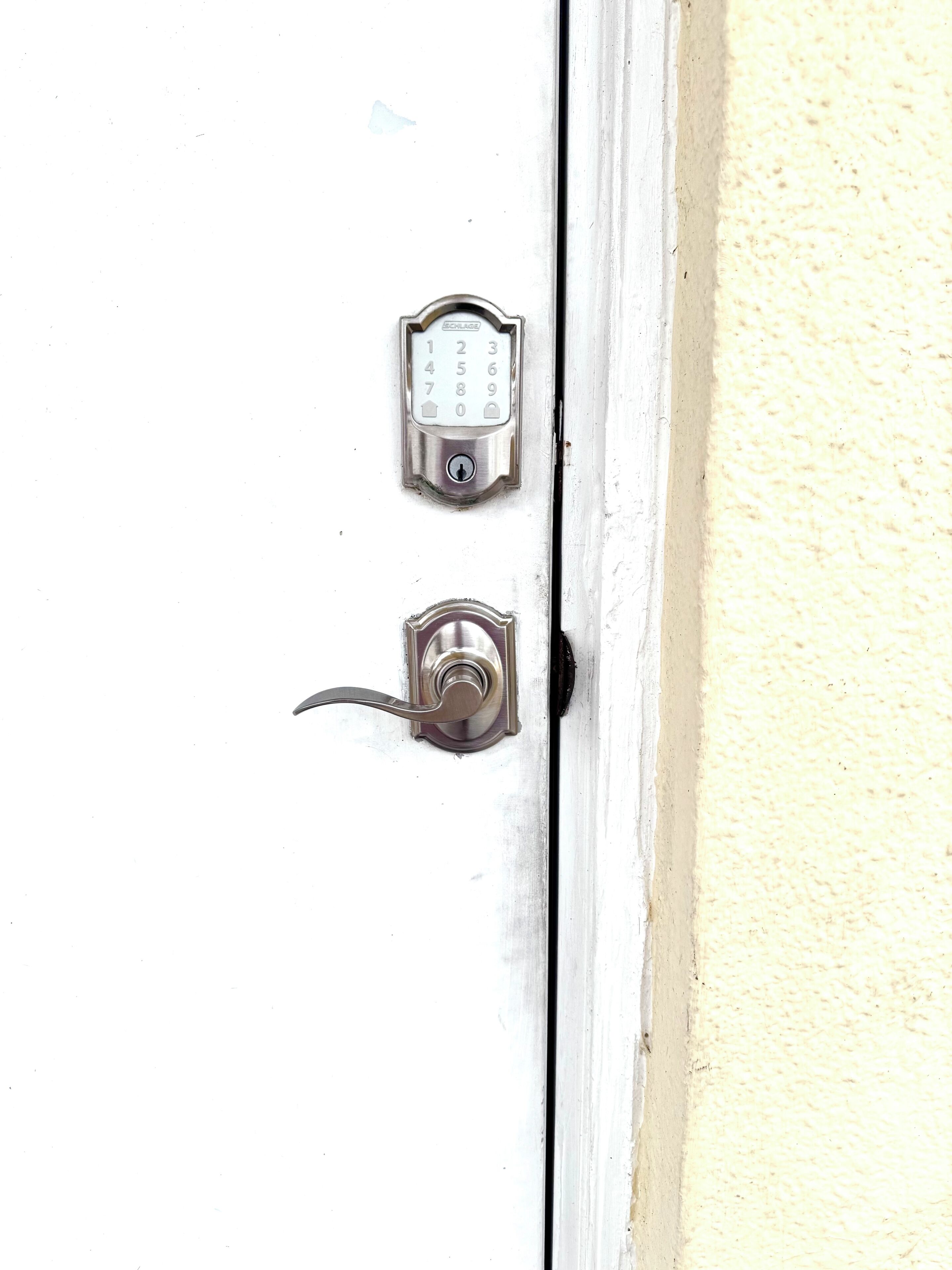 A door with a numeric keypad lock and a keyhole.